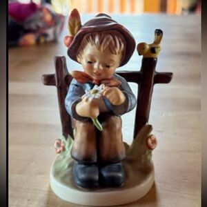 Goebel Hummel figurine titled "She Loves Me, She Loves Me Not"
